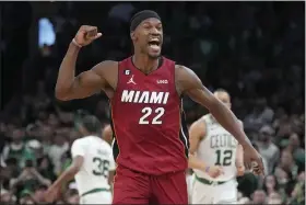 ?? CHARLES KRUPA — THE ASSOCIATED PRESS ?? Miami Heat forward Jimmy Butler (22) reacts after scoring against the Boston Celtics during the second half of Game 2of the NBA basketball playoffs Eastern Conference finals in Boston on Friday.