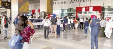  ?? Associated Press ?? ↑
People wait for their relatives and friends to come out of the Indira Gandhi Internatio­nal airport in New Delhi on Monday, .