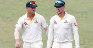  ?? – Reuters ?? FALLEN FROM GRACE: A file photo of Australia’s David Warner and Steve Smith leaving the pitch after their victory over South Africa in Durban.