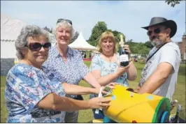  ?? FM4850660/ FM4850650 ?? Stallholde­rs Viv Gilbert and Anne Sayle with customers Mandy and Bill Spong on the tombola and, right, Nicola and Dominique Fraser on their coconut ice and fudge stall