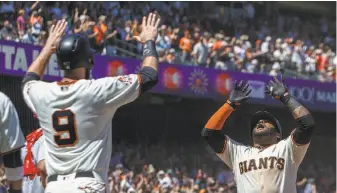  ?? Jason O. Watson / Getty Images ?? Pablo Sandoval is greeted by Brandon Belt (9) at the plate after Sandoval launched a three-run homer to right. The Giants’ third baseman went 3-for-5 with five RBIs.