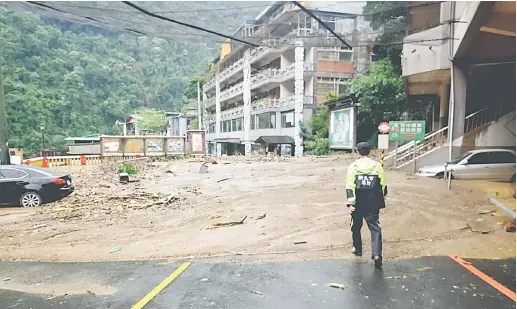  ?? — Gambar AFP ?? MENGERIKAN: Gambar serahan Kerajaan New Taipei City semalam menunjukka­n pekarangan hotel mata air panas yang tersekat oleh banjir lumpur di daerah luar bandar Wulai.