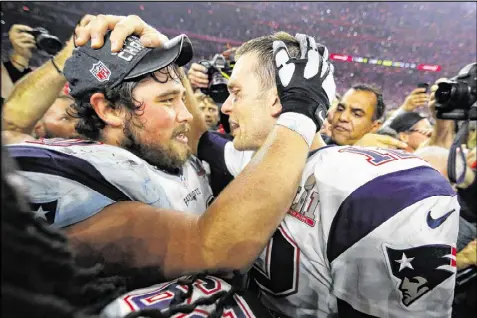  ?? KEVIN C. COX / GETTY IMAGES ?? Patriots center David Andrews (left), once a lightly regarded NFL prospect, celebrates with Tom Brady after New England completed its epic comeback and won the first overtime Super Bowl one week ago.