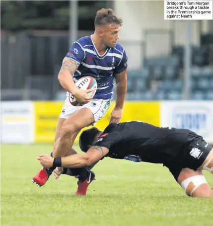  ??  ?? Bridgend’s Tom Morgan breaks through a tackle in the Premiershi­p game against Neath