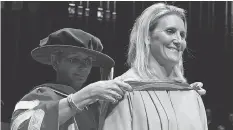  ?? LARRY WONG ?? Hayley Wickenheis­er receives an honorary diploma from Dr. Jodi Abbott, president of Edmonton’s NorQuest College, on Thursday.