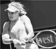  ??  ?? Bouchard hits a return against Kerber during their seventh session women’s singles match on day five of the Hopman Cup tennis tournament in Perth. — AFP photo