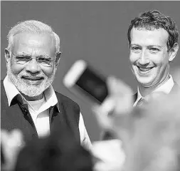 ?? Davi
d Paul Morris / Bloombe
rg ?? Facebook CEO Mark Zuckerberg, right, seen with Indian Prime Minister Narendra Modi, has met fierce opposition
to his plan to provide a free Internet service in India.