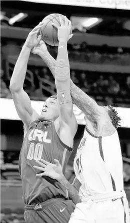  ?? JOHN RAOUX/AP ?? Magic forward Aaron Gordon collides with Nets forward Wilson Chandler as Gordon goes up for a shot in the first half Monday night at Amway Center. Gordon scored 11 points.