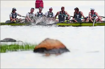  ?? SARAH GORDON/THE DAY ?? A rower with Yale University’s heavyweigh­t crew team’s first varsity rowers jumps into the water after their win in the 153rd Harvard-Yale Regatta on Saturday on the Thames River.