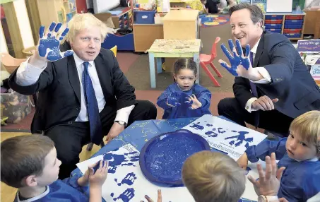  ??  ?? Hands up if you’re a true blue... Boris Johnson and the PM on a visit to a school in Surbiton, south London, yesterday