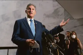  ?? J. Scott Applewhite / Associated Press ?? Sen. Joe Manchin, D-W.Va., briefs reporters Monday. He played a central role in negotiatio­ns over the plan that addresses climate change, energy, health care costs and deficit reduction.