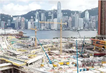  ?? — AFP photo ?? Photo shows the constructi­on site (foreground) of the West Kowloon terminus of the high-speed rail link which will connect the city to the southern Chinese city of Guangzhou, as Hong Kong’s skyline looms in the background.