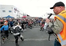  ??  ?? Southland Motorcycle Club president Andy Underhay, right, gives a riders briefing.
