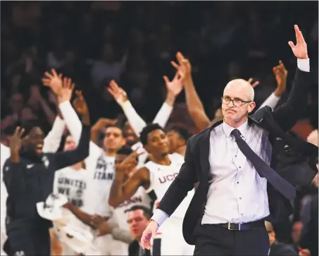  ?? Sarah Stier / Getty Images ?? UConn coach Dan Hurley reacts as the bench celebrates after a Huskies rebound in the first half of Thursday’s game against Syracuse in the 2k Empire Classic at Madison Square Garden in New York.