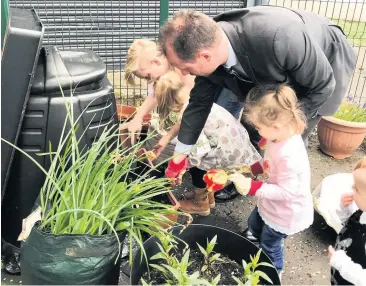  ??  ?? Green fingers Mr Gray is no stranger to nature, as shown during a past visit to Gartlea community centre