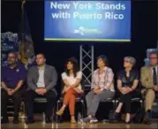  ?? THE ASSOCIATED PRESS ?? Rosie Perez, third from left, listens as Governor Andrew Cuomo announces new hurricane recovery efforts for Puerto Rico Sunday in New York.