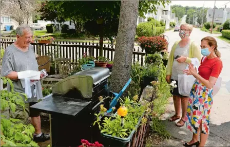  ?? PHOTOS BY DANA JENSEN/THE DAY ?? Above, Lt. Gov. Susan Bysiewicz, right, and state Sen. Cathy Osten, second from right, talk with Fred Molocko, left, in his front yard about the 2020 census Tuesday in the Taftville section of Norwich. Below, Osten, center, hands Hope Jencks, right, 2020 census gift items while she and Bysiewicz, left, talk about the census. Bysiewicz, Osten and others walked around the neighborho­od talking to people about the census and handing out census gifts.