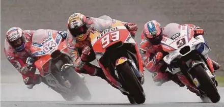  ?? AFP PIC ?? Honda rider Marc Marquez (centre) leads Ducati riders Andrea Dovizioso (left) and Danilo Petrucci during the Japanese Grand Prix yesterday.