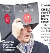  ??  ?? SHELTER Punter at Cheltenham yesterday