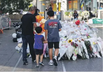  ?? GETTY IMAGES ?? People lay flowers outside Westfield Shopping Centre in honour of the victims of the Bondi Junction killings. The attack and the stabbing of an outspoken bishop, which sparked a riot, have raised tensions in Sydney.