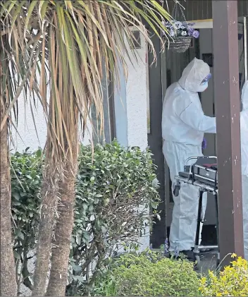  ??  ?? Undertaker­s in personal protective equipment arrive at Home Farm care home, on Skye, in May. Ten elderly residents died there after an outbreak of Covid-19