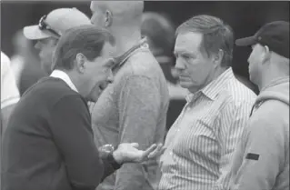  ?? ASSOCIATED PRESS FILE PHOTO ?? Nick Saban, left, speaks with Patriots coach Bill Belichick during Alabama’s pro day in Tuscaloosa, Ala., in March.