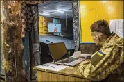  ??  ?? Radio operator Alexei Brodskyi keeps an eye on Russia’s opening World Cup match last week at a Ukrainian army command center in Avdiivka, Ukraine.