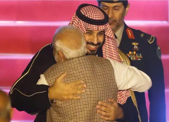  ?? (Reuters) ?? MbS hugs Narendra Modi, whom he referred to as his older brother