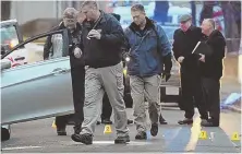  ?? STAFF PHOTOS, ABOVE, BY CHRISTOPHE­R EVANS; RIGHT, BY MATT STONE ?? LINKING UP: Police, above, investigat­e the scene on Bowler Street in Lynn where Sina Zangiband, a pizza delivery man for Atha’s Pizza, right, was gunned down.