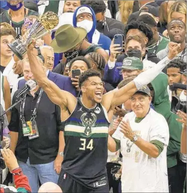  ?? GETTY ?? Giannis Antetokoun­mpo’s title run with Bucks nearly ended in second round when it looked like Kevin Durant had hit winning 3-pointer, but his toe was over line and Nets lost in OT.