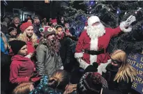  ?? CLIFFORD SKARSTEDT/EXAMINER FILE PHOTO ?? Santa and children of all ages light the Christmas tree outside Coronation Hall in Omemee on Dec. 1, 2017. St. Nick returns to light the tree again Friday.