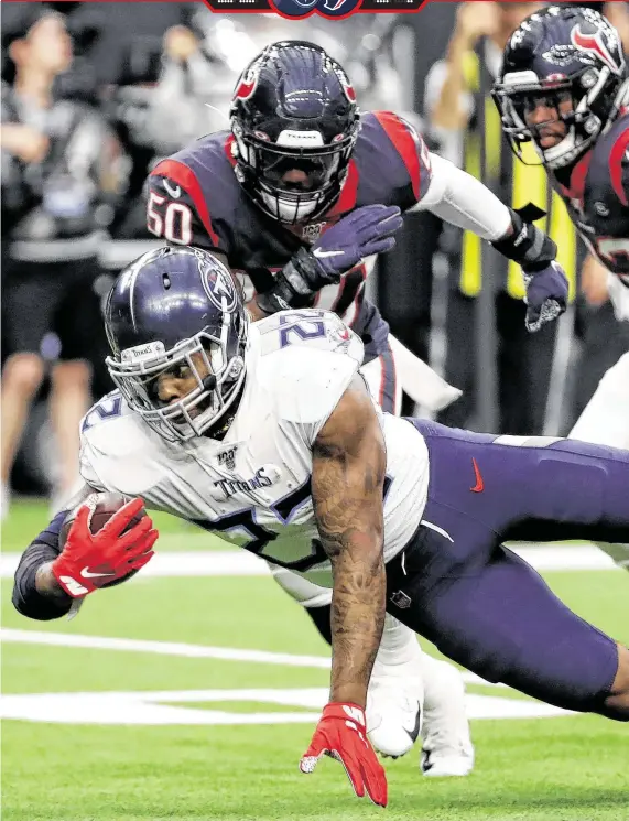  ?? Brett Coomer / Staff photograph­er ?? The Titans’ Derrick Henry, diving for extra yards past the Texans’ Tyrell Adams, rushed for a season-high 211 yards and three touchdowns Sunday at NRG Stadium.