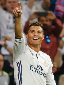  ??  ?? Cristiano Ronaldo celebrates after completing his hat-trick