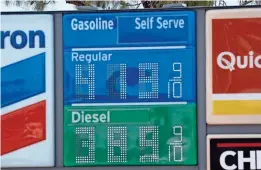  ?? MARK HENLE/THE REPUBLIC ?? Gas prices are seen at a Quick Run store Friday in Mesa.