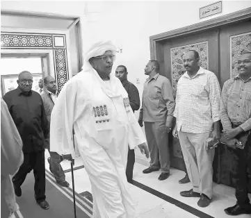  ??  ?? Saleh walks out after being named prime minister during a meeting on party leadership in Khartoum, Sudan. — Reuters photo