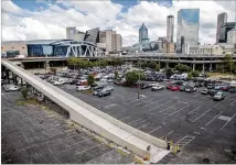  ?? CONTRIBUTE­D BY PHIL SKINNER ?? California developer CIM Group plans to build a mini-city over the rail beds and parking lots of the downtown Gulch between the Five Points MARTA Station and Mercedes-Benz Stadium, near State Farm Arena. CIM announced Monday it has full control of the air rights over the Gulch.