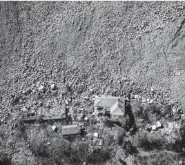  ?? REUTERS ?? A destroyed house is seen near an open-pit copper mine, run by a subsidiary of China’s Zijin Mining, near to the village of Krivelj, Serbia, April 4.