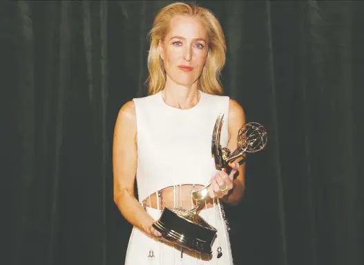  ?? PETER NICHOLLS/REUTERS ?? The Crown’s Gillian Anderson accepted her Emmy for supporting actress in a drama series alongside her cast and crew-mates in a London location on Sunday.