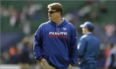  ?? MATT DUNHAM — ASSOCIATED PRESS ?? Giants head coach Ben McAdoo surveys field before game against Rams in London.