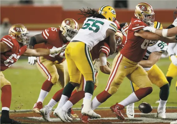  ?? Photos by Scott Strazzante / The Chronicle ?? Niners quarterbac­k Nick Mullens fumbles while being sacked by Green Bay’s Za’Darius Smith in the third quarter during Thursday night’s loss at Levi’s Stadium.