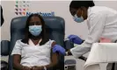  ?? Photograph: Getty Images ?? Sandra Lindsay, left, is inoculated with the Covid-19 vaccine by Dr Michelle Chester, in the Queens borough of New York City