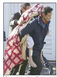  ?? AP ?? A person injured in a fire is carried from a hospital in Miryang, South Korea yesterday.