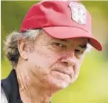  ?? AP ?? “Caddyshack” actor Michael O’Keefe dons “Bushwood” cap as he works during Monday’s U.S. Open practice round.