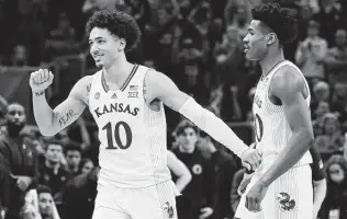  ?? Stacy Revere / Getty Images ?? Kansas’ Jalen Wilson and Ochai Agbaji celebrate after Friday’s win over Providence in the Sweet 16. The Jayhawks overtook Kentucky as college basketball’s winningest program.