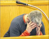  ?? TARA BRADBURY/THE TELEGRAM ?? David Snow, 36, hides his face from media cameras as he sits in the dock at Newfoundla­nd and Labrador Supreme Court in St. John’s Tuesday afternoon.