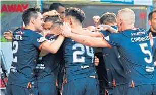  ??  ?? Peter Pawlett is mobbed after grabbing United’s winner at Firhill.