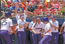  ?? THE ASSOCIATED PRESS ?? Washington celebrates a home run by Julia DePonte, left center, in the fifth inning of its Women’s College World Series game against Oklahoma on Sunday afternoon in Oklahoma City.