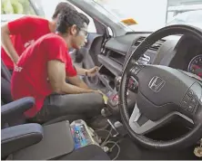  ?? AP FILE PHOTO ?? GLOBAL RECALL: A Honda technician performs a free replacemen­t of a Takata air bag in Malaysia in 2016.