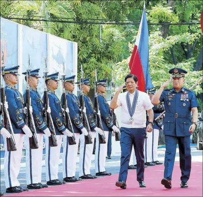  ?? KRIZJOHN ROSALES ?? President Marcos, accompanie­d by PAF chief Lt. Gen. Stephen Parreño, arrives at Villamor Airbase in Pasay City for the Philippine Air Force command conference yesterday.