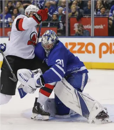  ?? RICK MADONIK/TORONTO STAR ?? Leafs goalie Frederik Andersen, forced to wrap up New Jersey winger Jimmy Hayes after losing his stick, had his share of struggles Wednesday, allowing six goals on 31 shots. The Devils’ Cory Schneider stopped 47 of 50 shots at the other end.